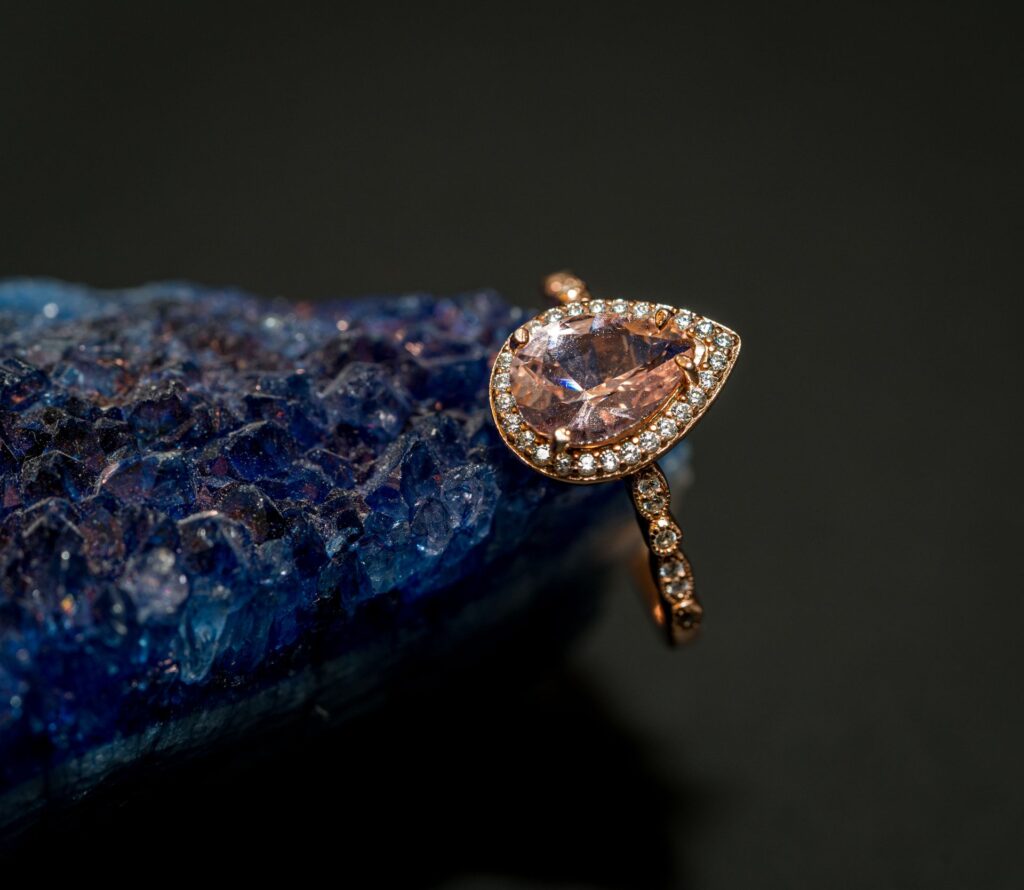 Gemstone ring resting on a deep blue sparkling surface